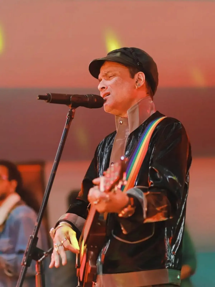 Zubeen Garg performing live with guitar and rainbow-colored